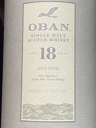A bottle of oban single malt scotch whisky is sitting on a table.