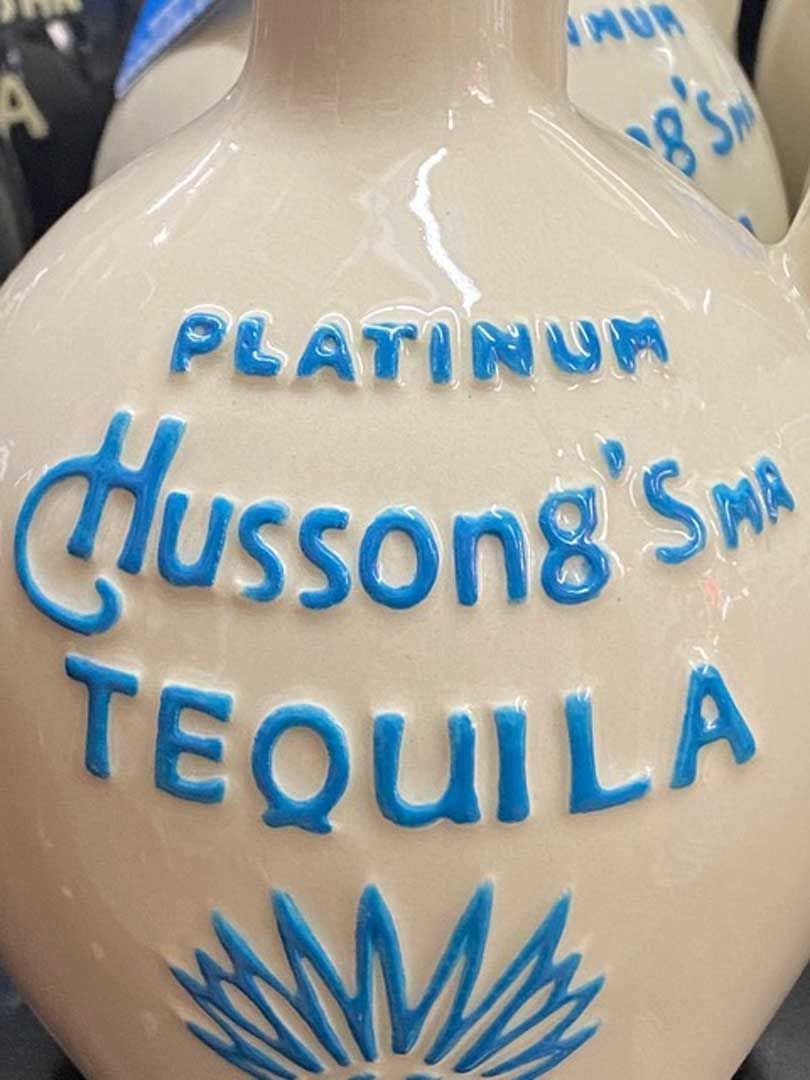 A close up of a bottle of hussong 's tequila