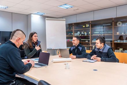 Shop team reviewing profit plans together in a meeting