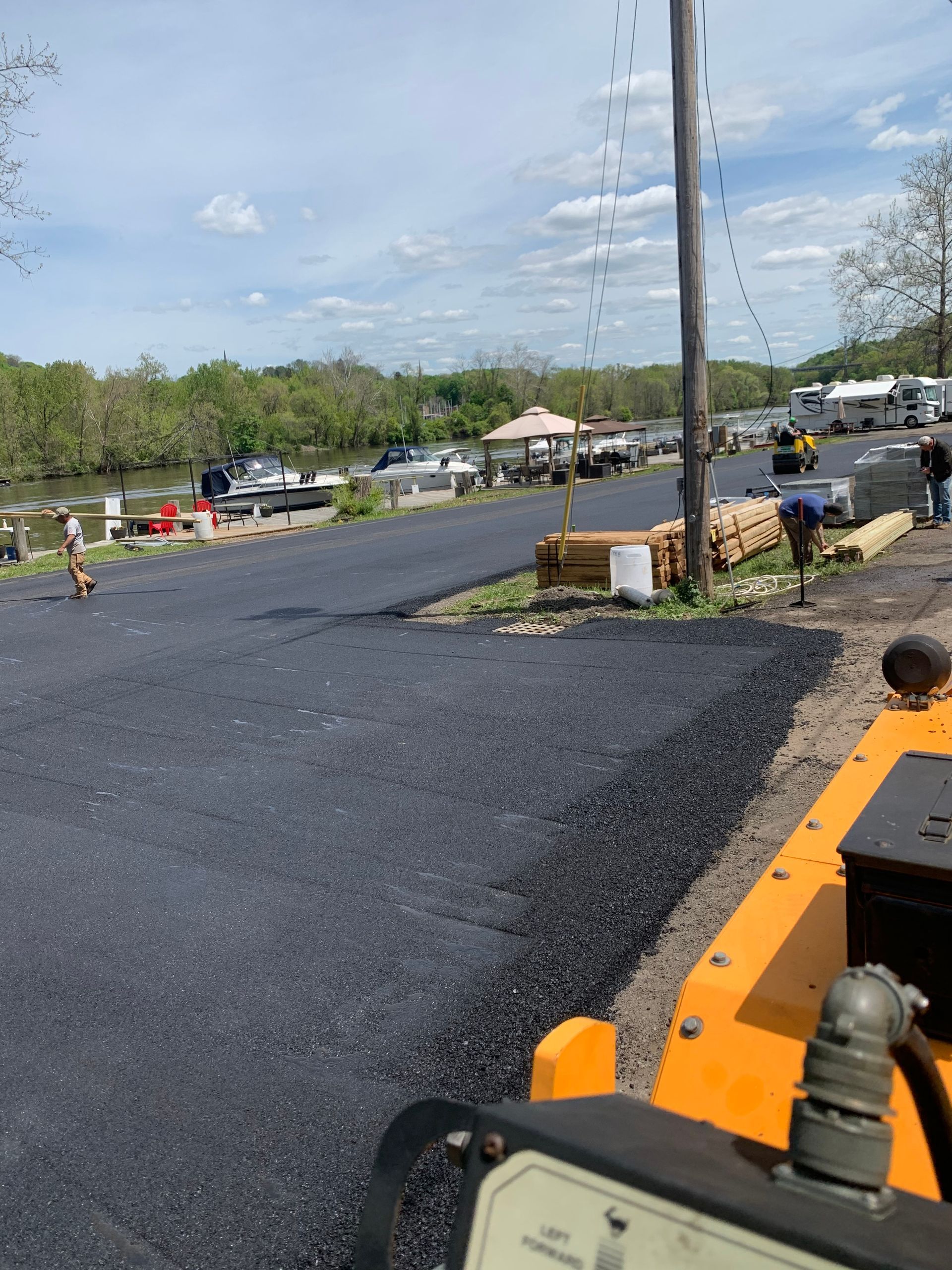 A yellow truck is parked on the side of a road