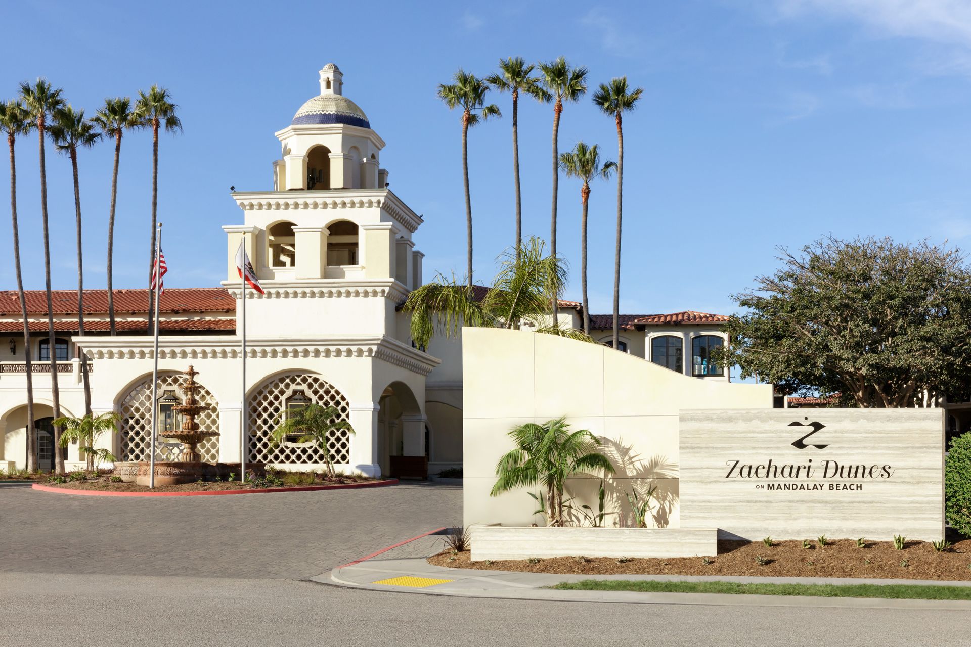 A large white building with palm trees in front of it