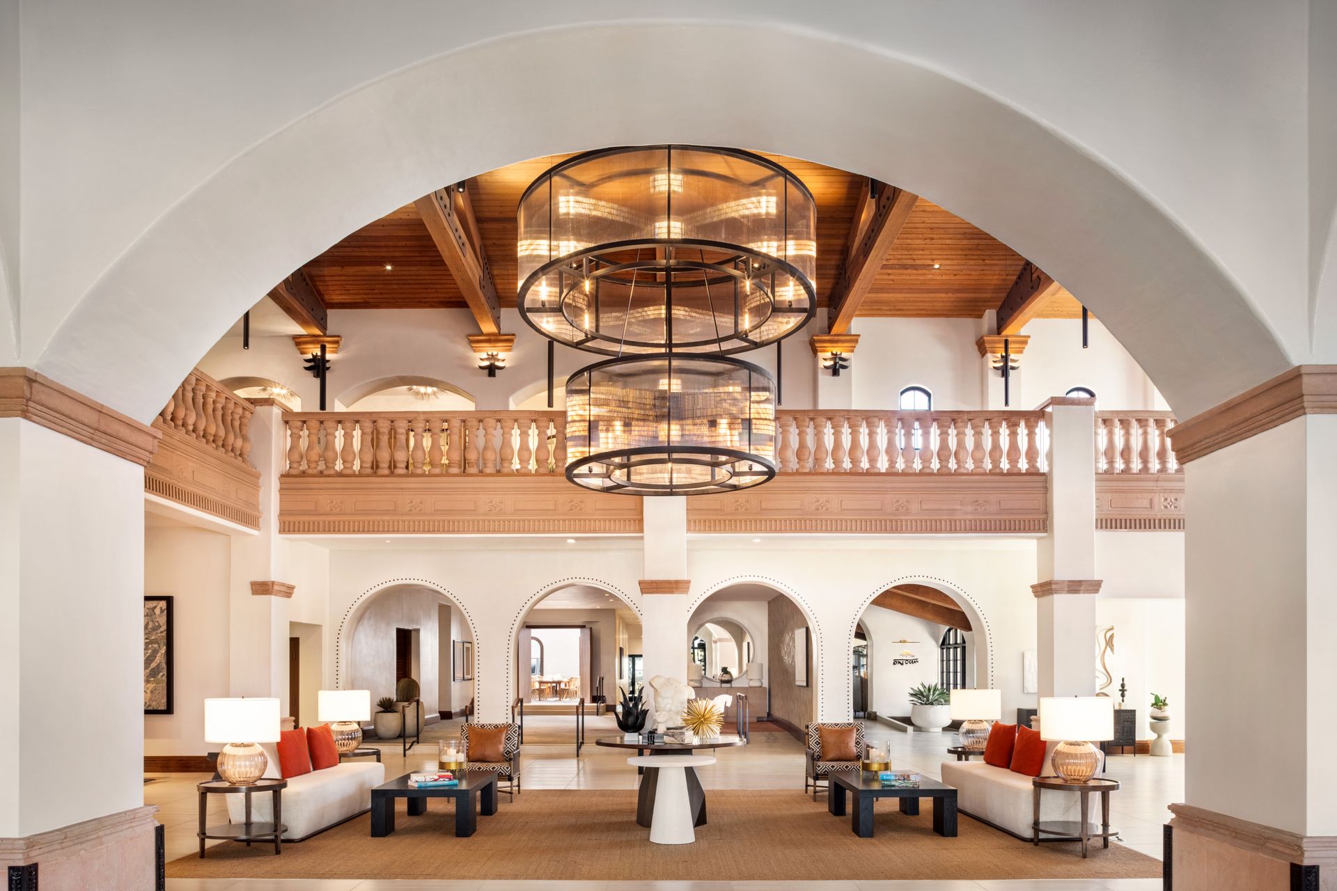 The lobby of a hotel with a large chandelier hanging from the ceiling.
