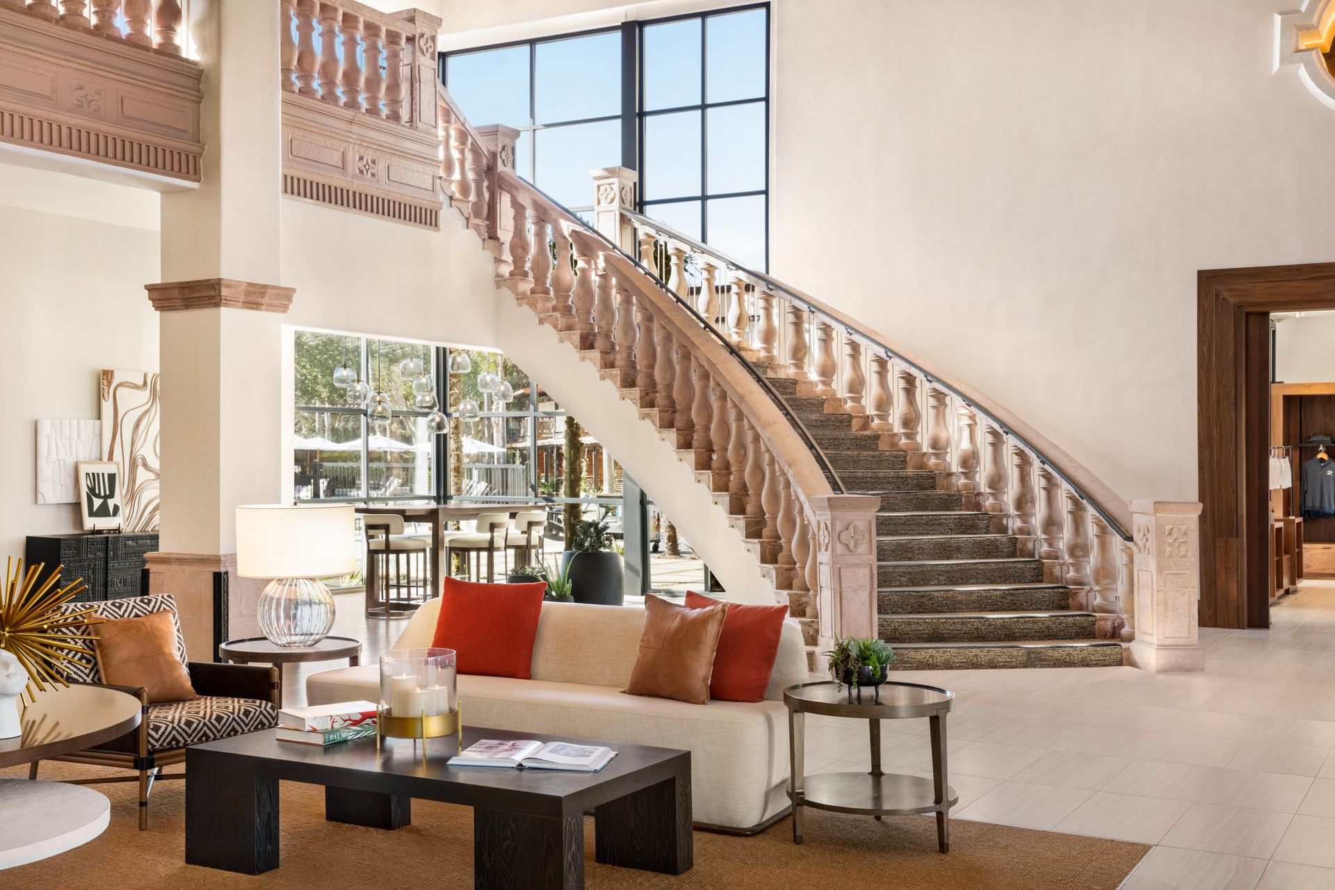 A living room with a couch and stairs in the background