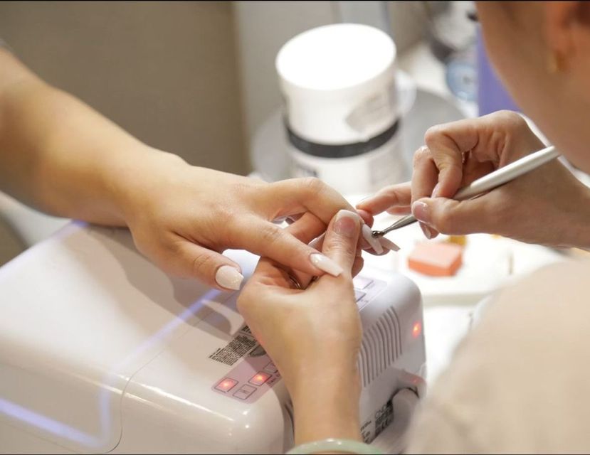 Client receiving a professional manicure in a modern salon