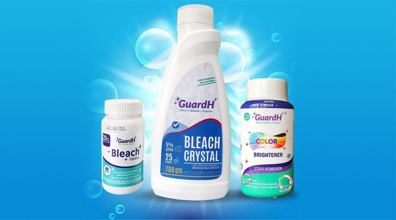 Three bottles of bleach are sitting next to each other on a blue background.