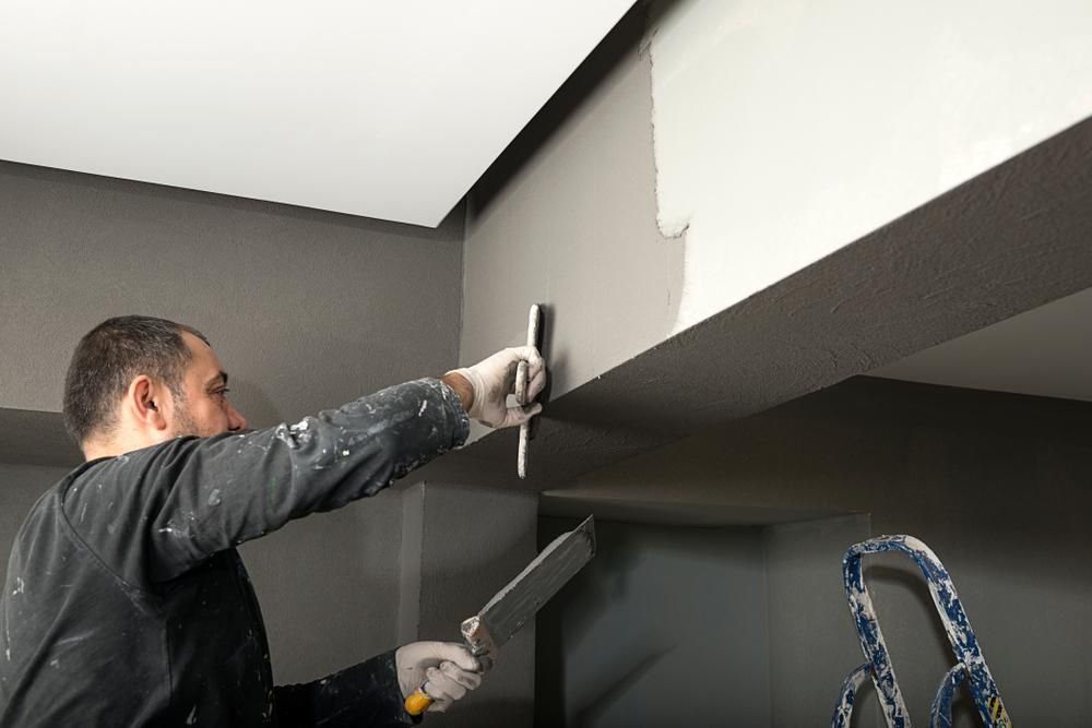 Yellow Walls with Paintbrushes on the floor — Cutting Edge Painting Contractors QLD in The Dawn, QLD