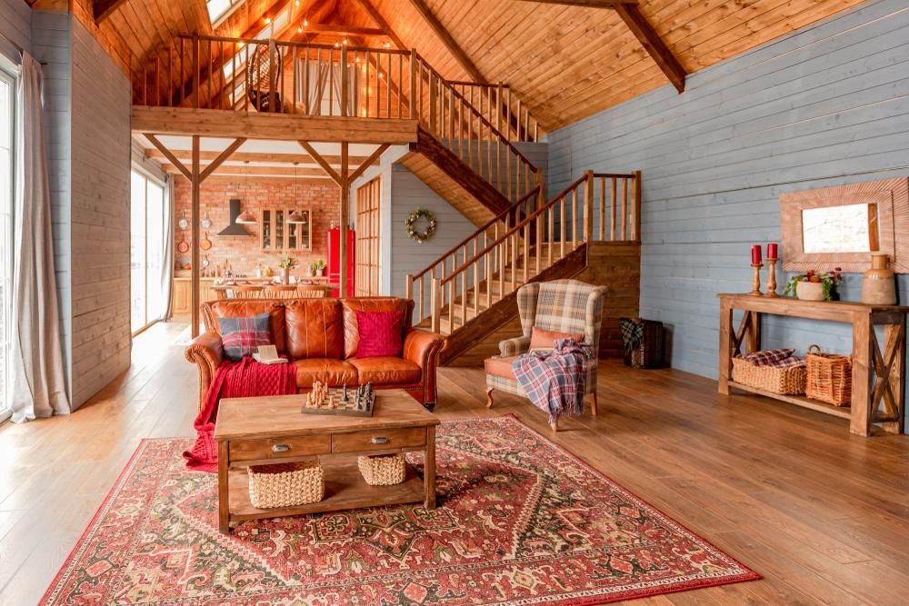 A Living Room With a Couch , Chair , Coffee Table and Stairs — Cutting Edge Painting Contractors QLD in The Dawn, QLD