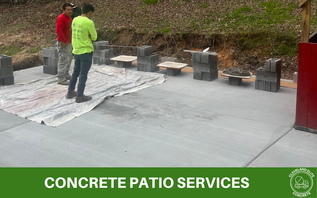 image of a concrete patio being laid, with text at the bottom that says concrete patio services, along with the Cleveland elite concrete logo in the bottom right