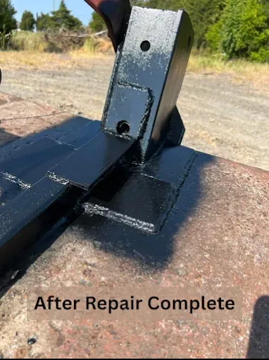 A metal piece welded onto a surface, freshly painted black, with the caption 