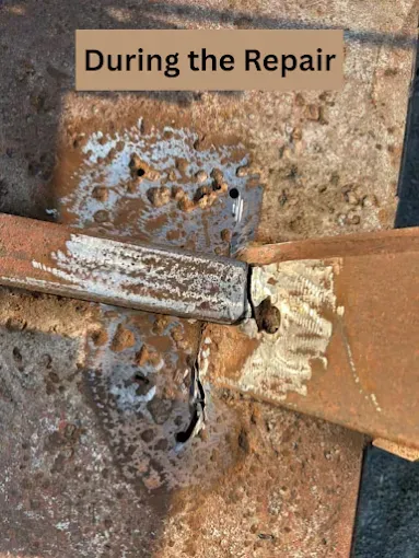 A close-up of a metal repair in progress, showing a rectangular metal bar being welded to a larger, rusted metal plate.