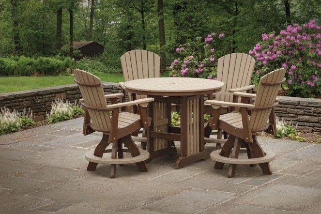 A table and chairs are sitting on top of a lush green lawn.
