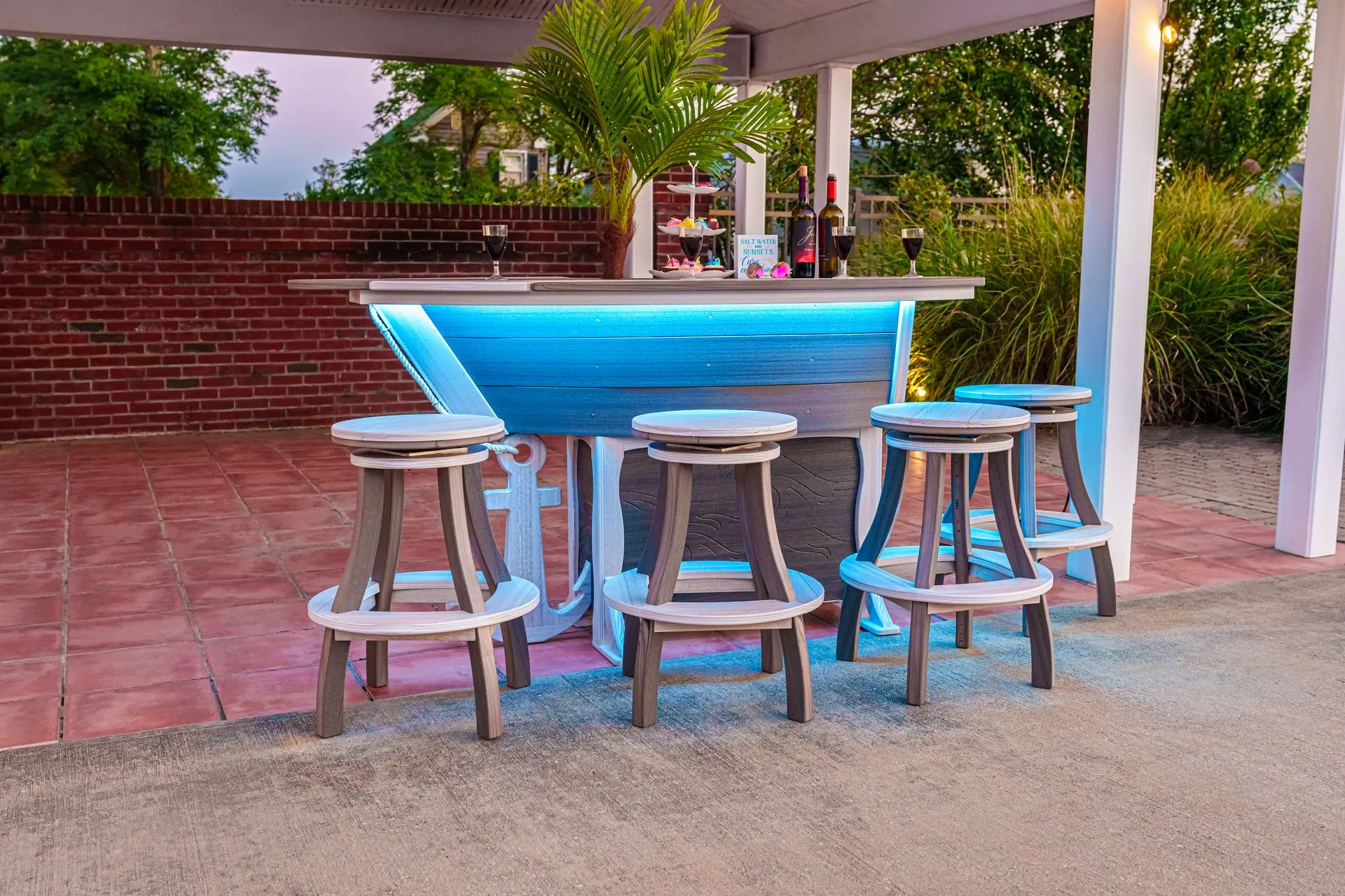 A table and chairs are sitting on top of a lush green lawn.