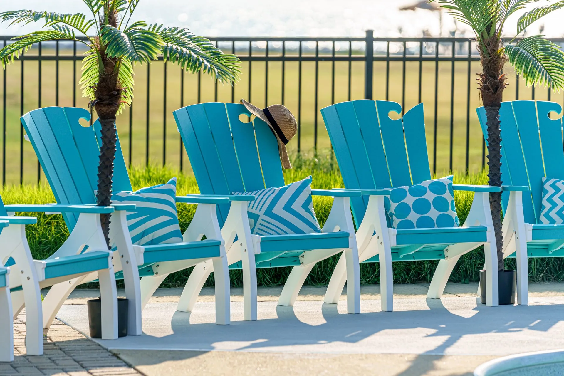 A green and white patio set with a table and chairs