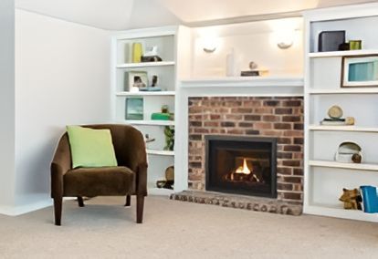 A black fireplace with flames coming out of it