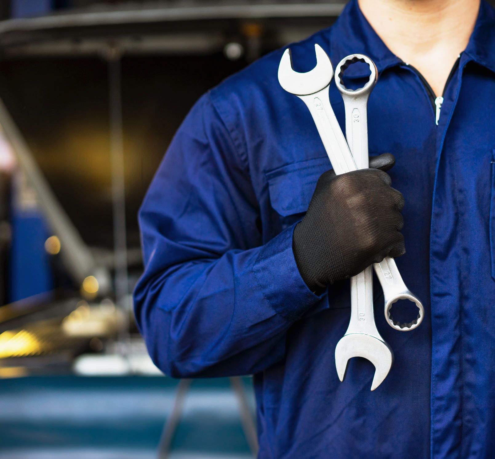 Man Holding Wrenches — Los Angeles, CA — Rv Radiator & Muffler Inc Man Holding Wrenches — Los Angeles, CA — Rv Radiator & Muffler Inc