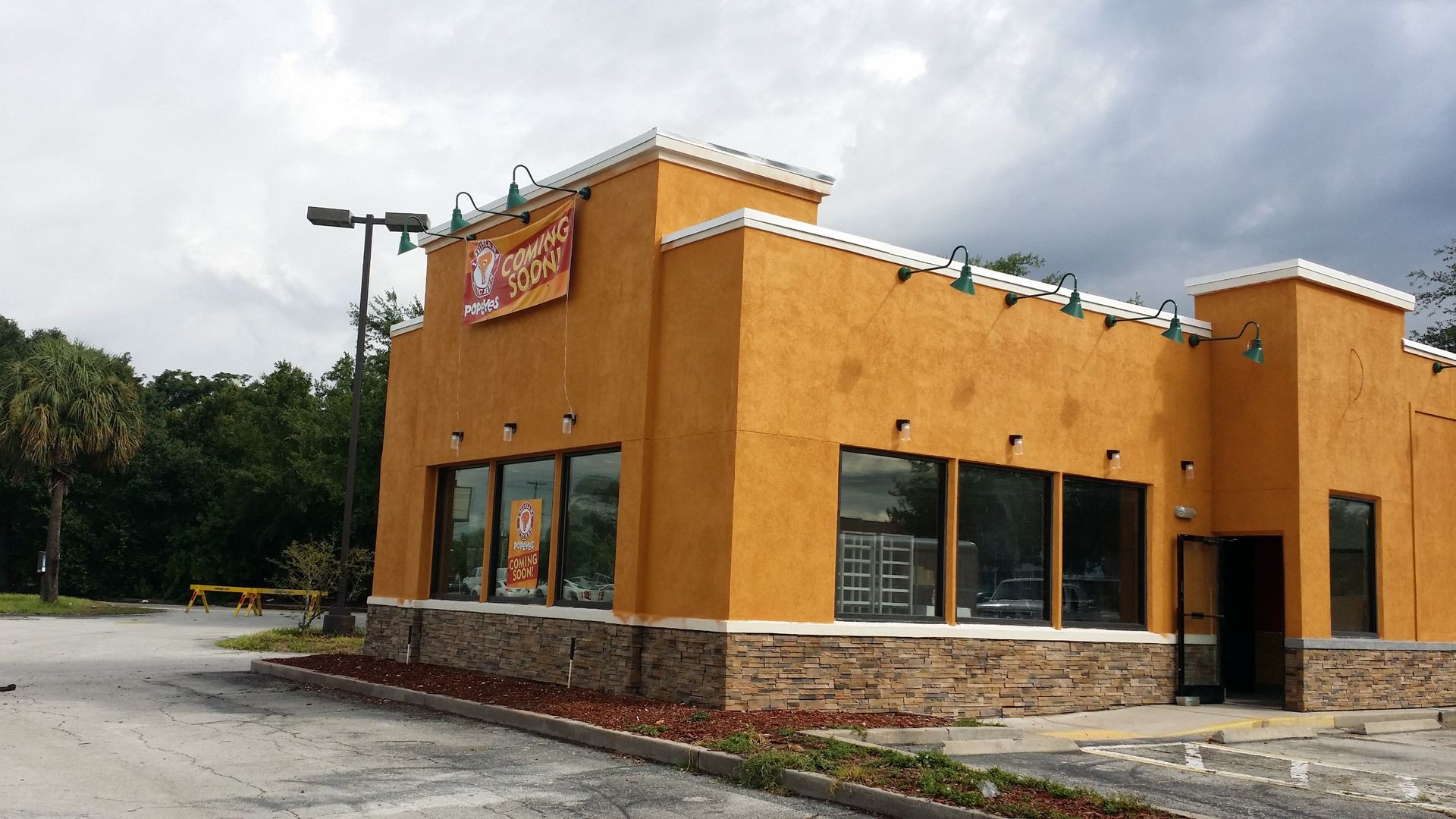 A large orange building with a sign that says ' taco bell ' on it