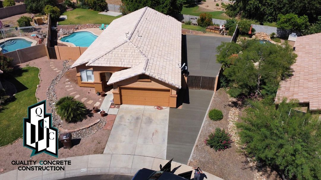 An aerial view of a house with a pool in the backyard