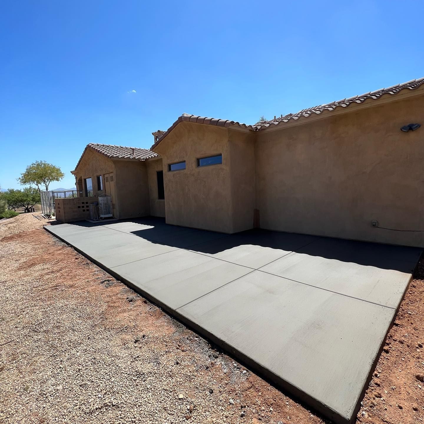 A house with a concrete driveway in front of it