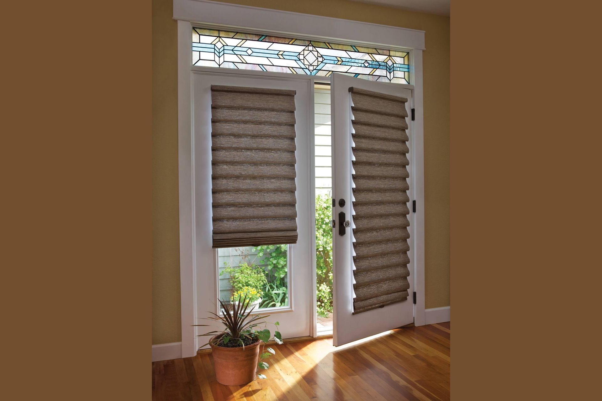 French doors with pleated shades, stained glass transom, and potted plant.