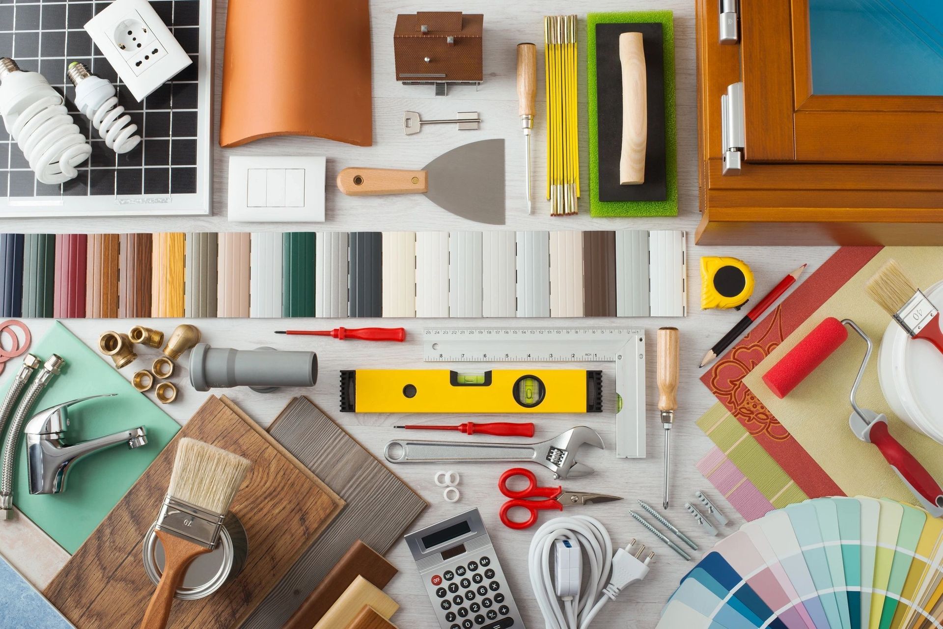 A table topped with a variety of tools and materials for home improvement.
