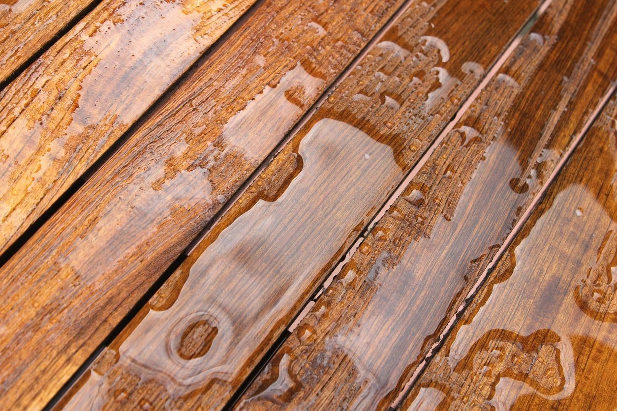 A close up of a wooden surface with water drops on it