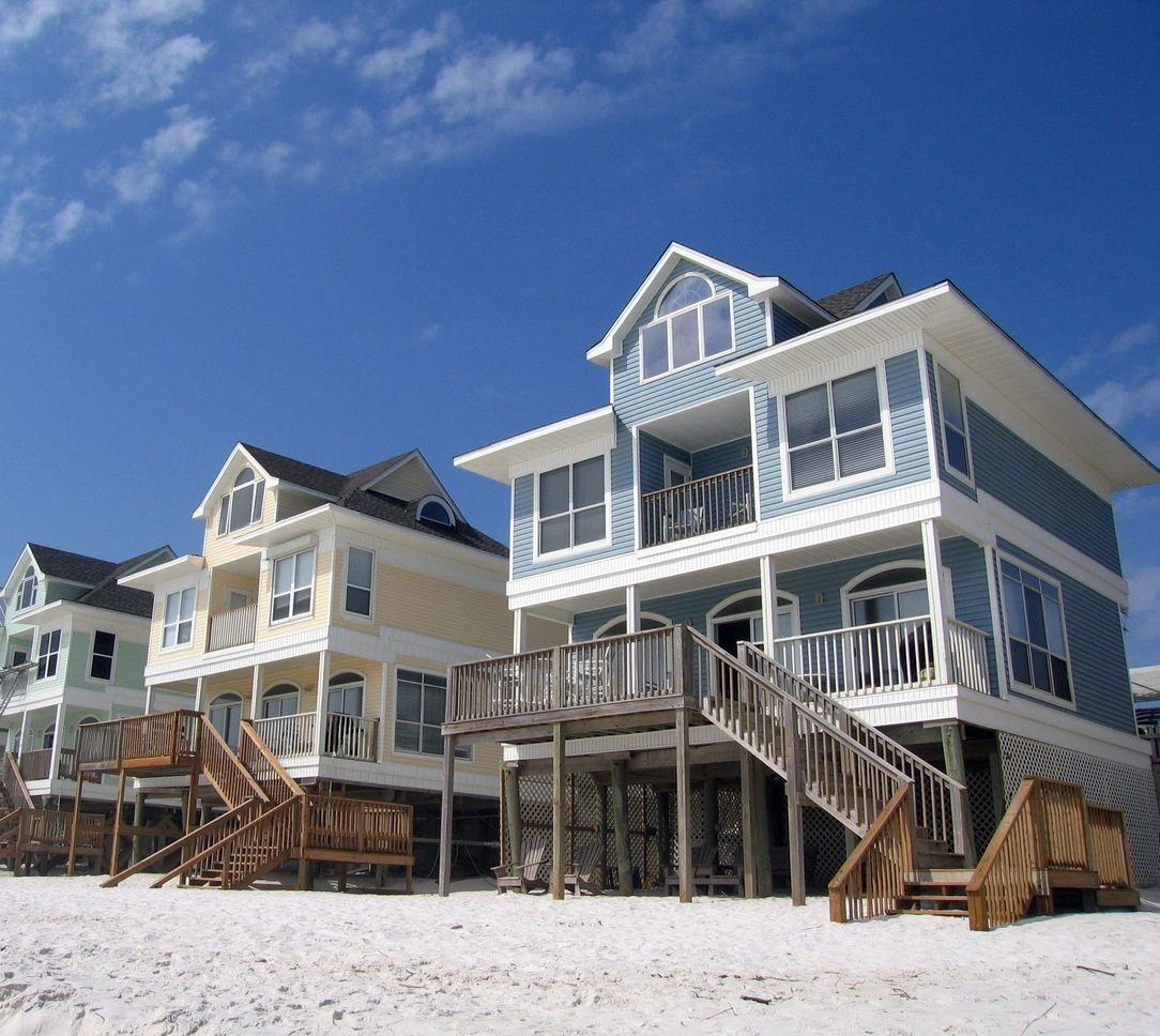 A row of houses on stilts on the beach
