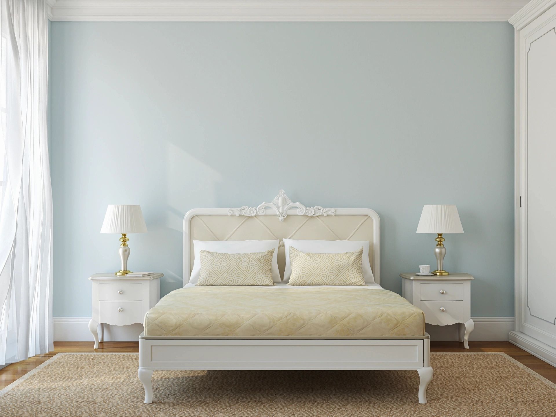 A bedroom with a bed , nightstands , lamps and blue walls.
