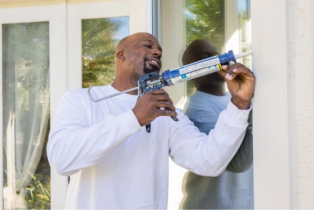 man with calk gun