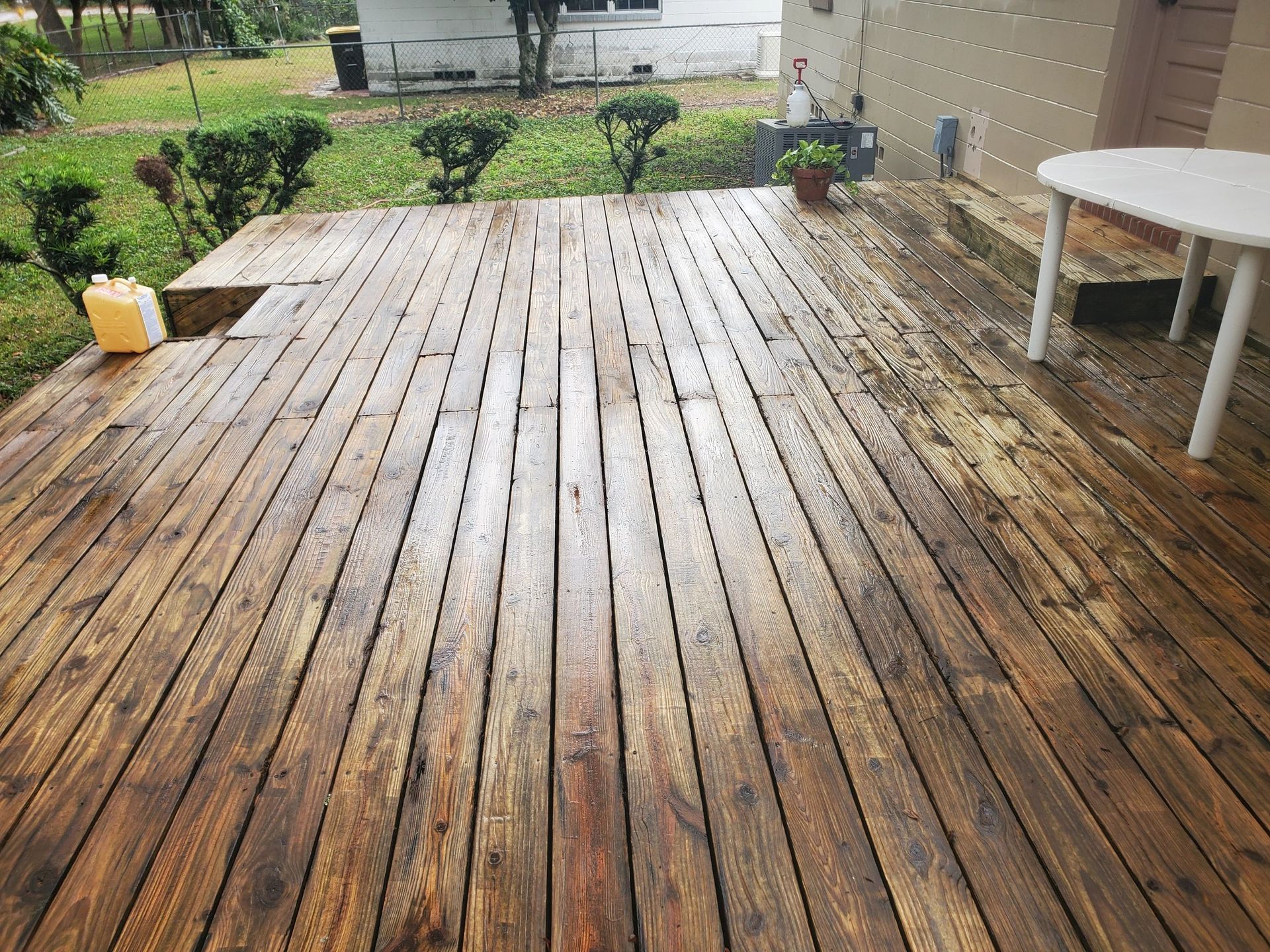 A wooden deck with a table and chairs on it.