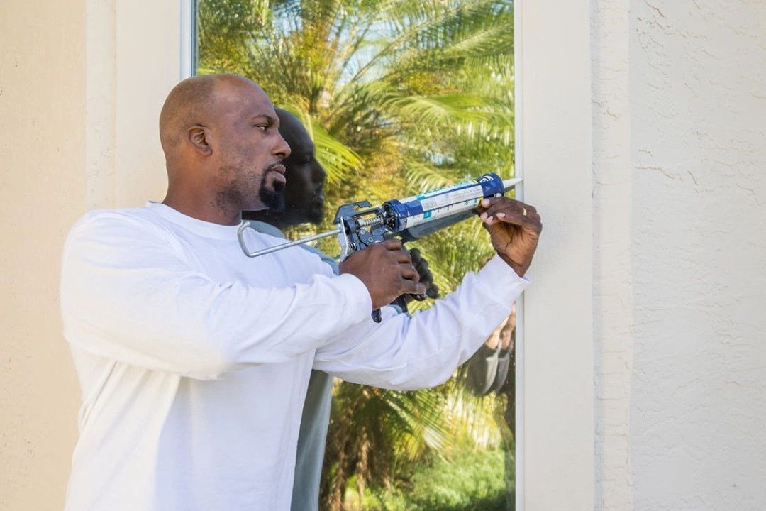 man with calk gun