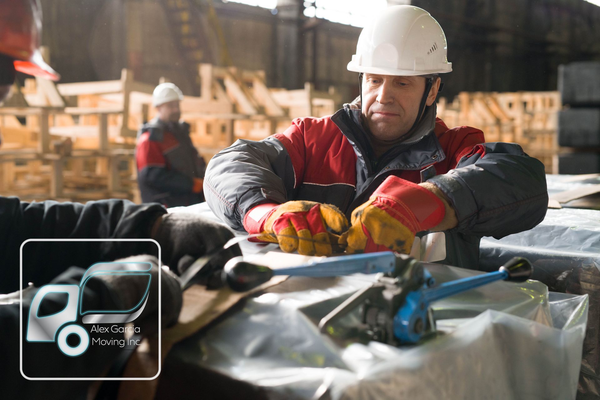 A man wearing a hard hat is working on a piece of metal.