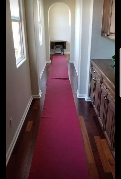 A long hallway with a red carpet on the floor