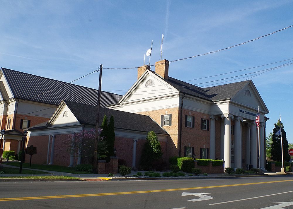 A large brick building sits on the corner of a street