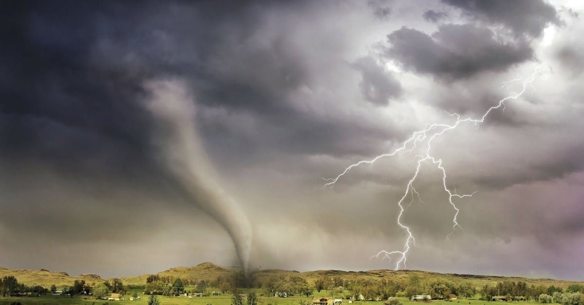 There is a tornado and lightning in the sky.