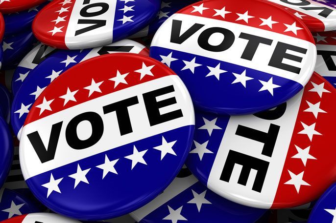 A pile of red white and blue vote buttons