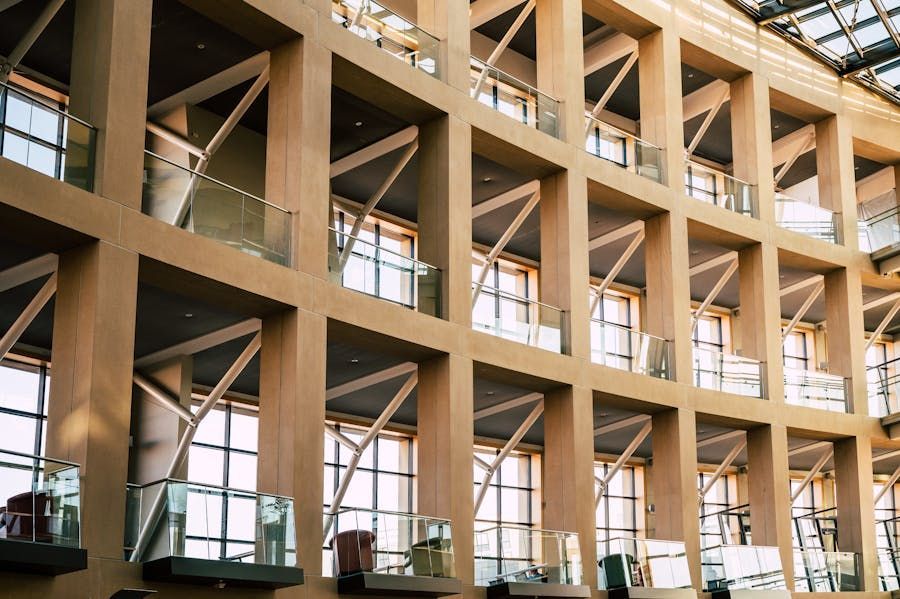 Interior of a modern wooden building with large windows and open balconies