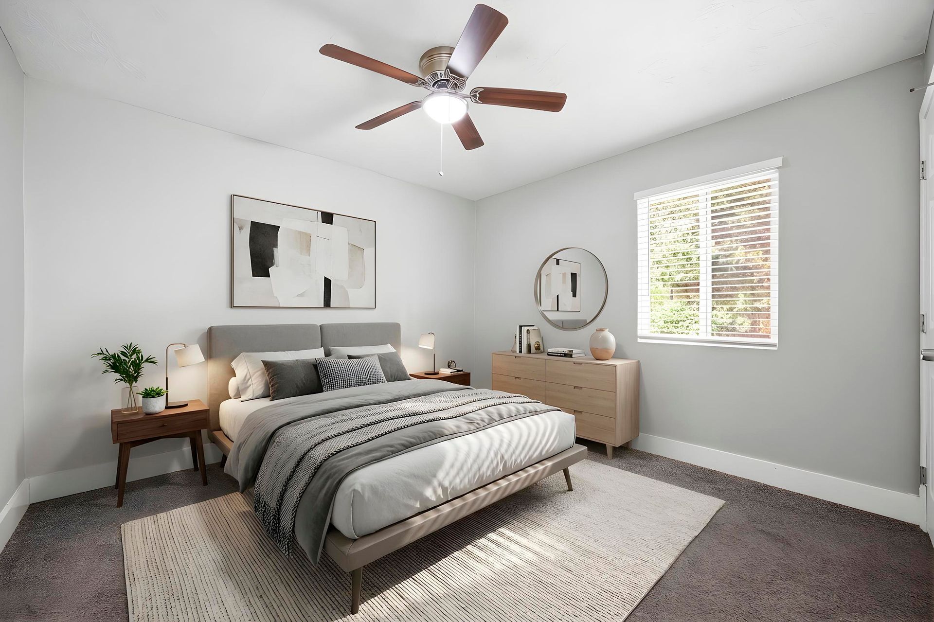 Bright bedroom with gray bed, beige dresser, ceiling fan, and window with blinds
