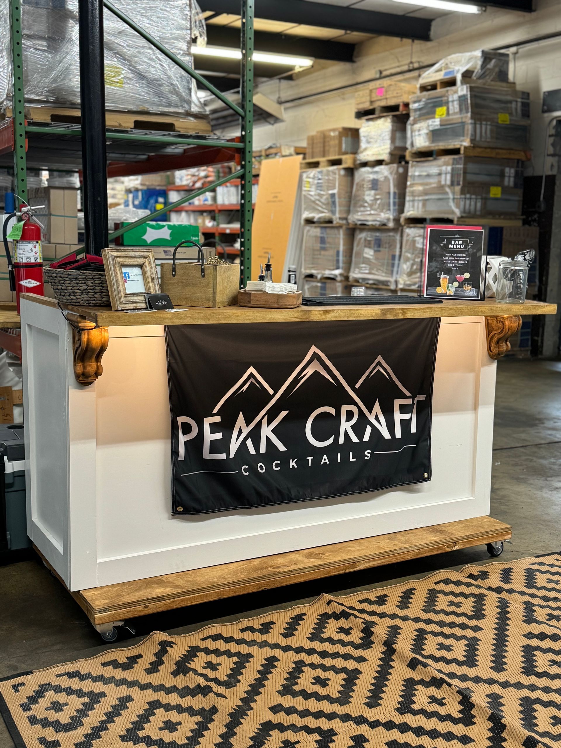 A bar in a warehouse with a sign that says peak craft on it.
