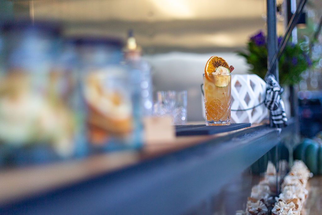 A close up of two drinks on a shelf in a restaurant.