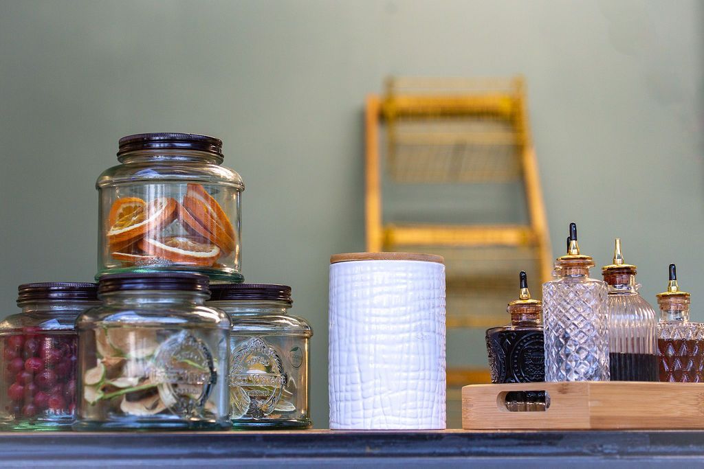 A stack of jars sitting on top of a counter.