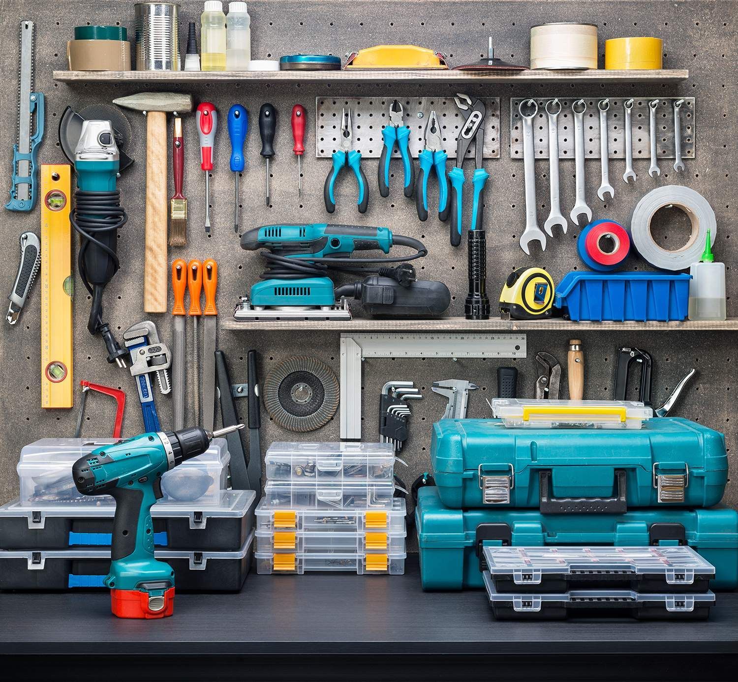 a bunch of tools are hanging on a wall including a drill .