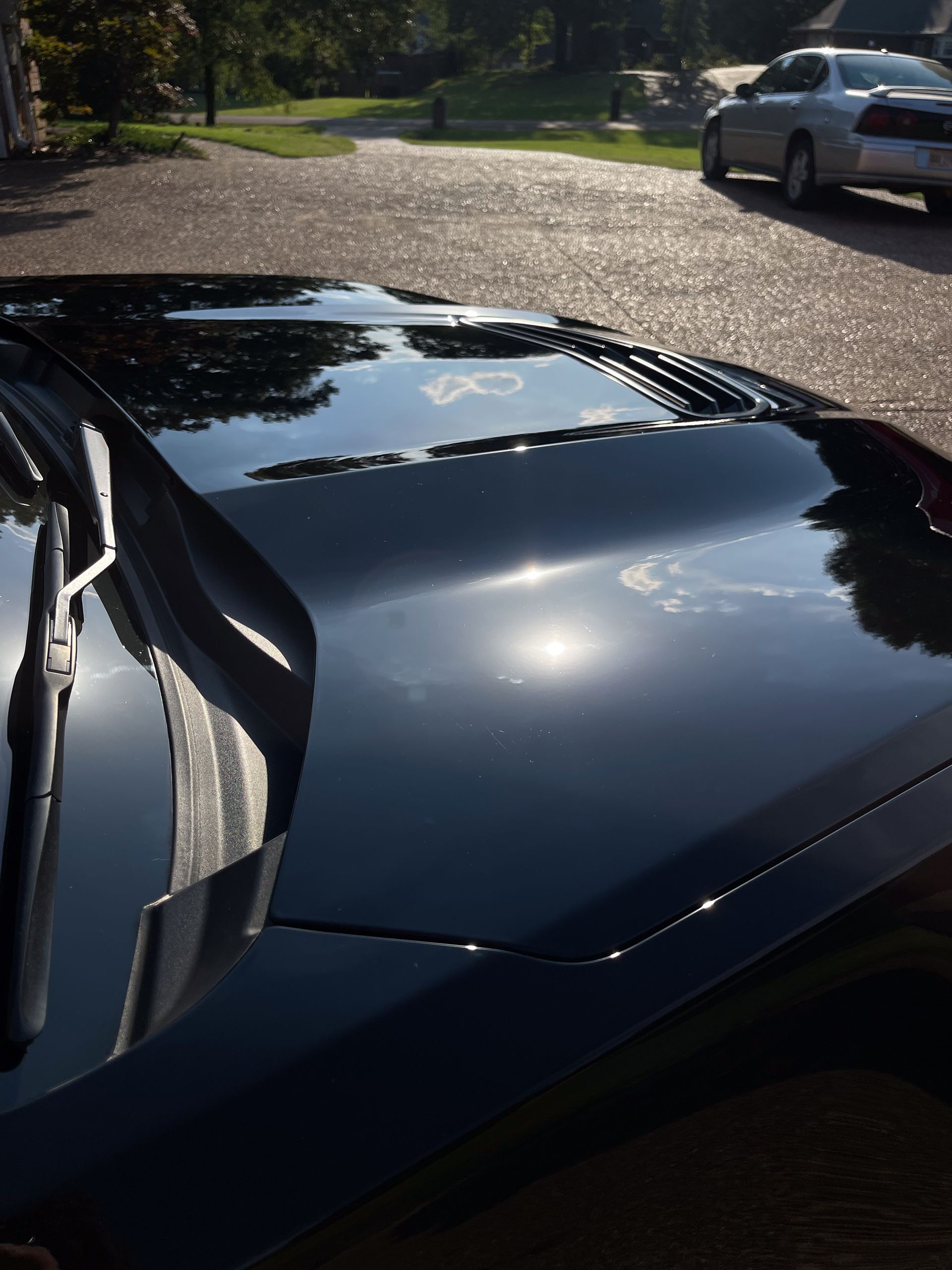a black car is parked on the side of the road