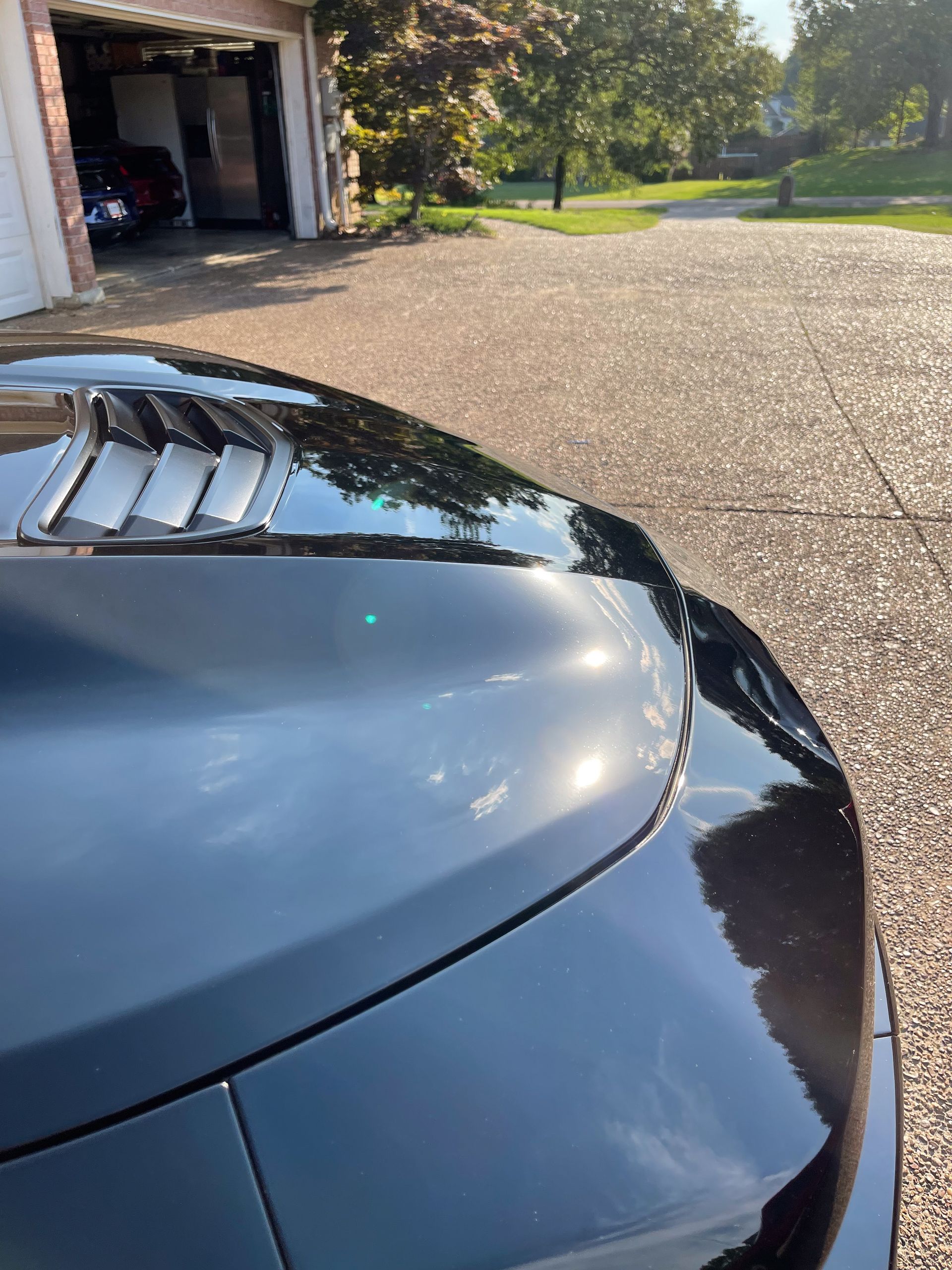 Close-up of a car's hood with a glossy ceramic coating finish