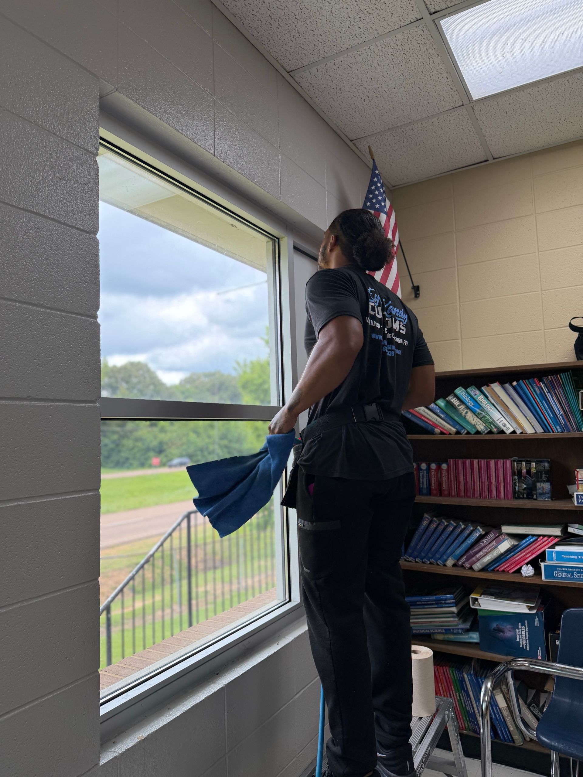 Cleaning classroom glass before applying commercial window film