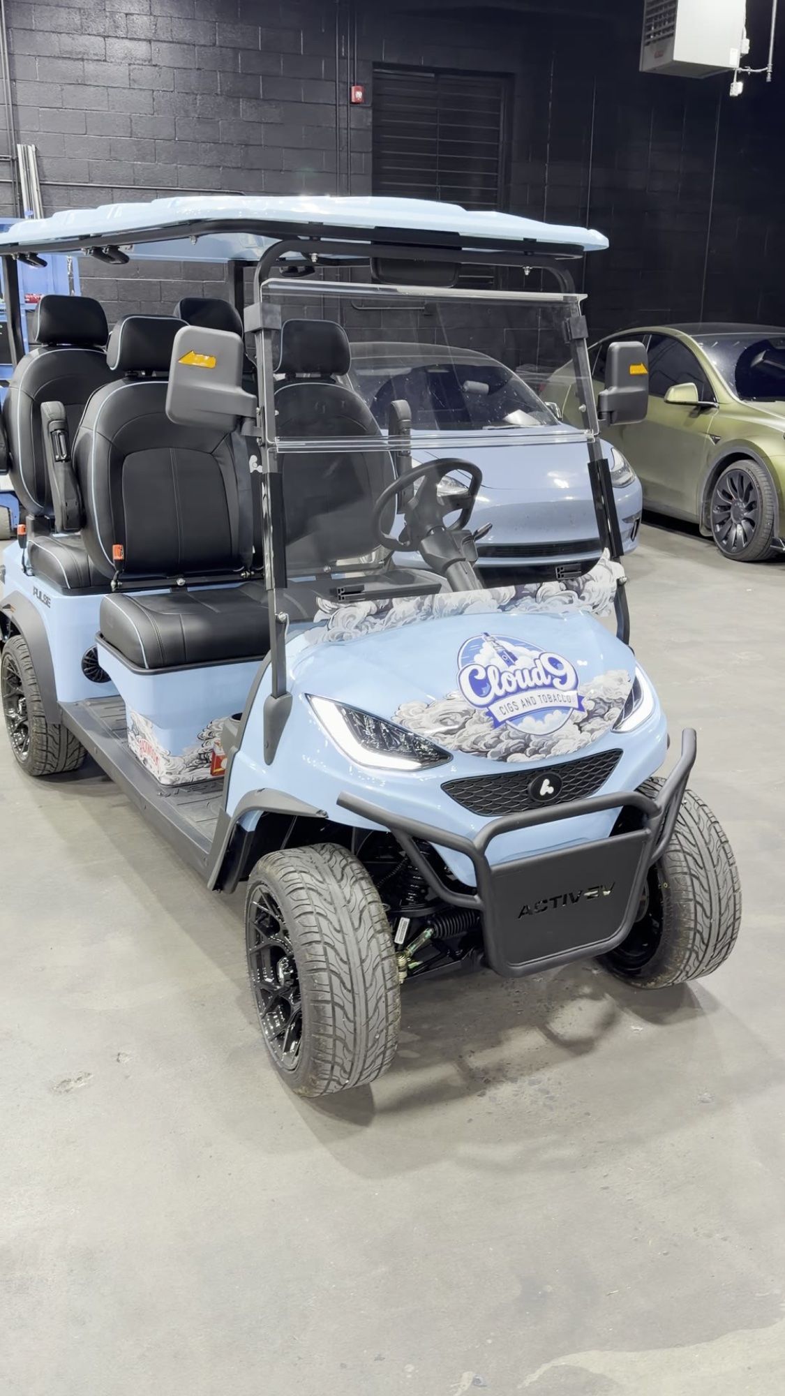 Front of the Cloud 9 golf cart showing the custom logo