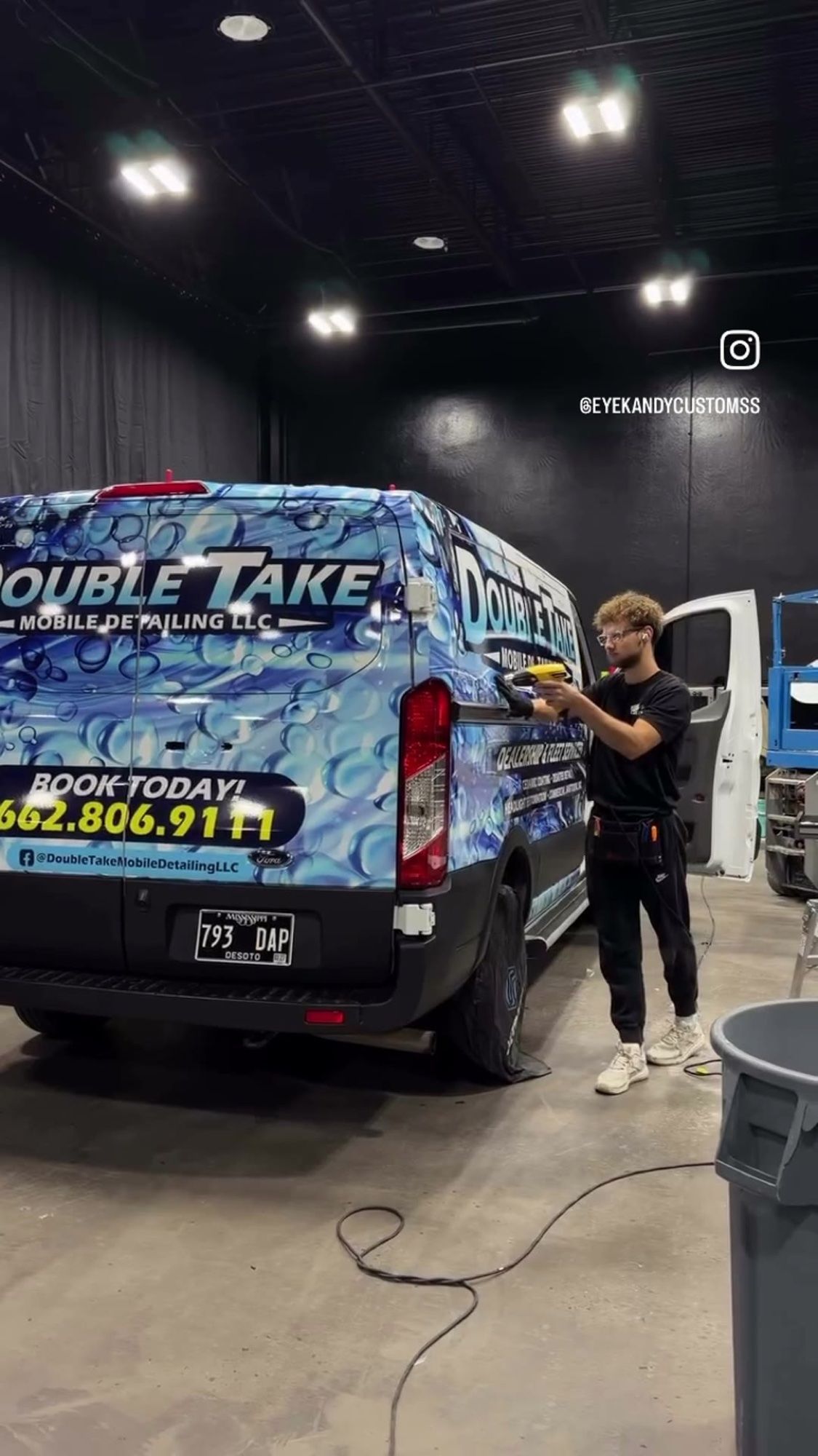 Eye Kandy Customs installer finishing the Double Take van wrap