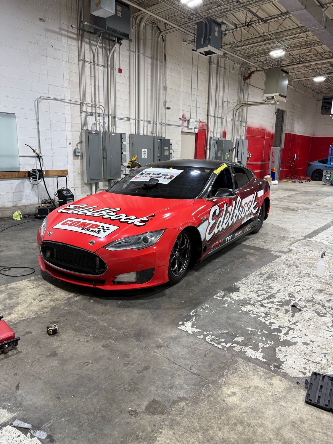 Edelbrock Tesla Model S race car wrapped in red, black, and white by Eye Kandy Customs