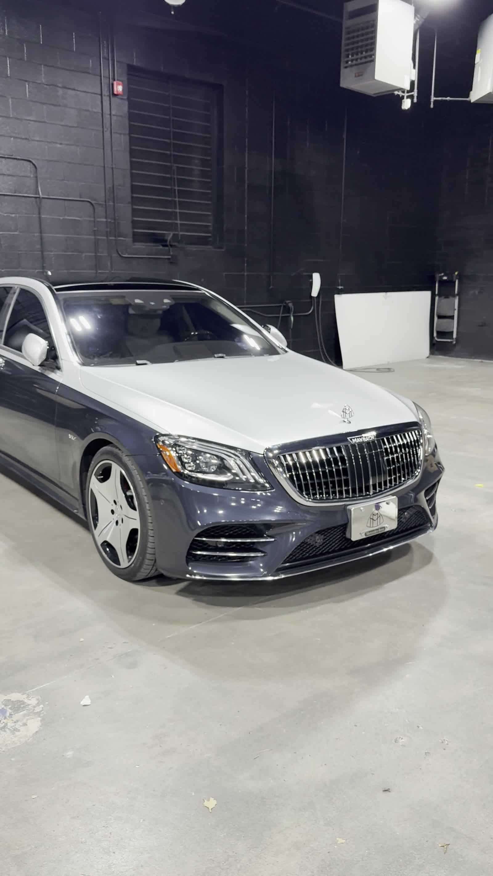 Close-up of silver wrapped hood and Maybach grille
