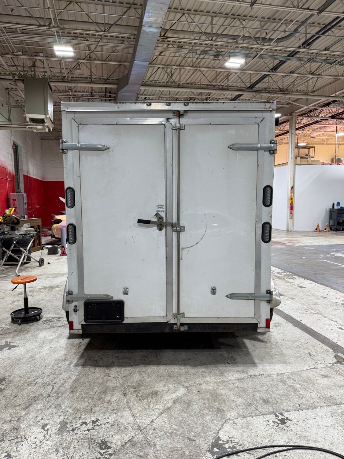 Plain white National Gutter Alliance trailer before the wrap