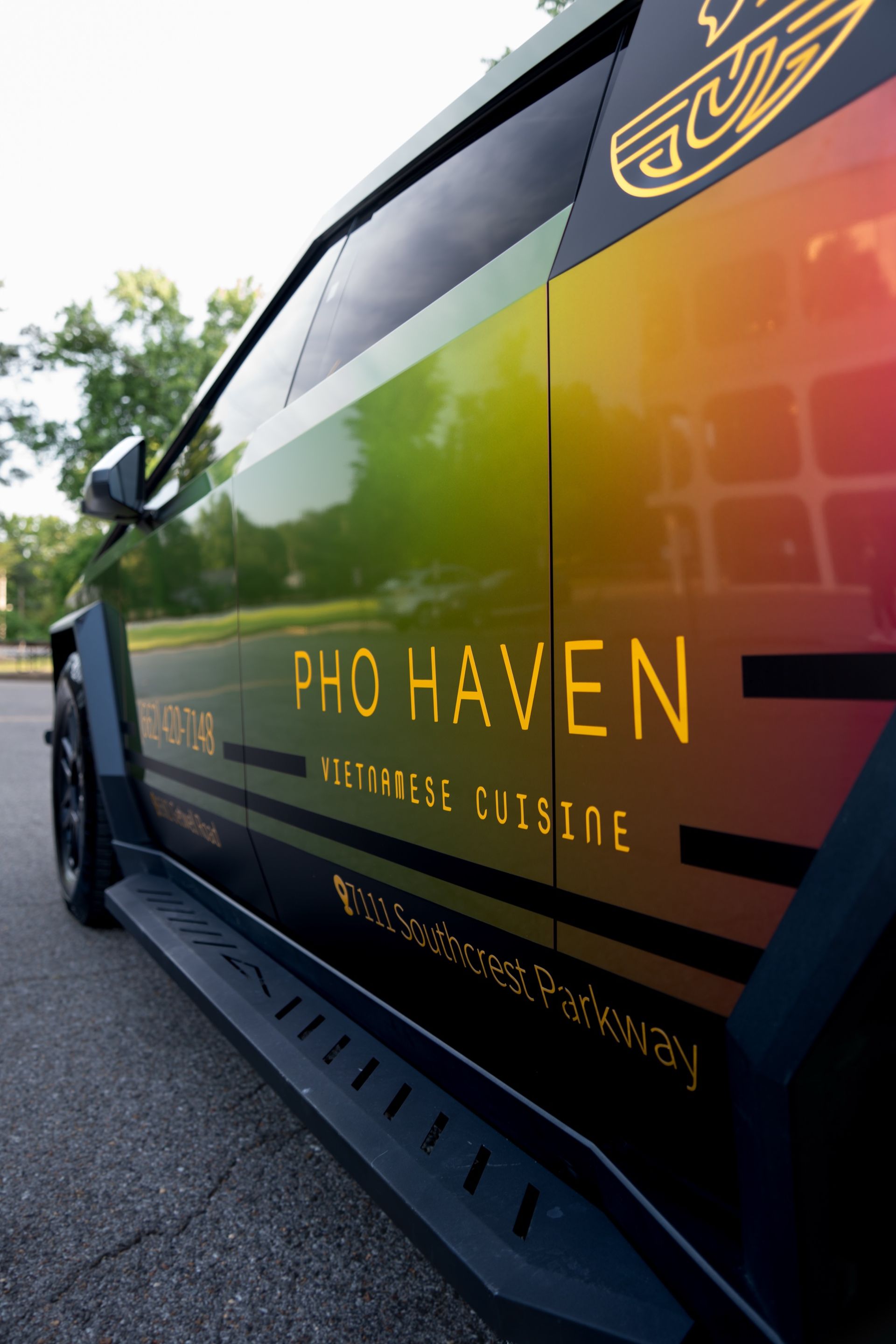 Gold chrome Pho Haven logo over color shift vinyl on the Cybertruck